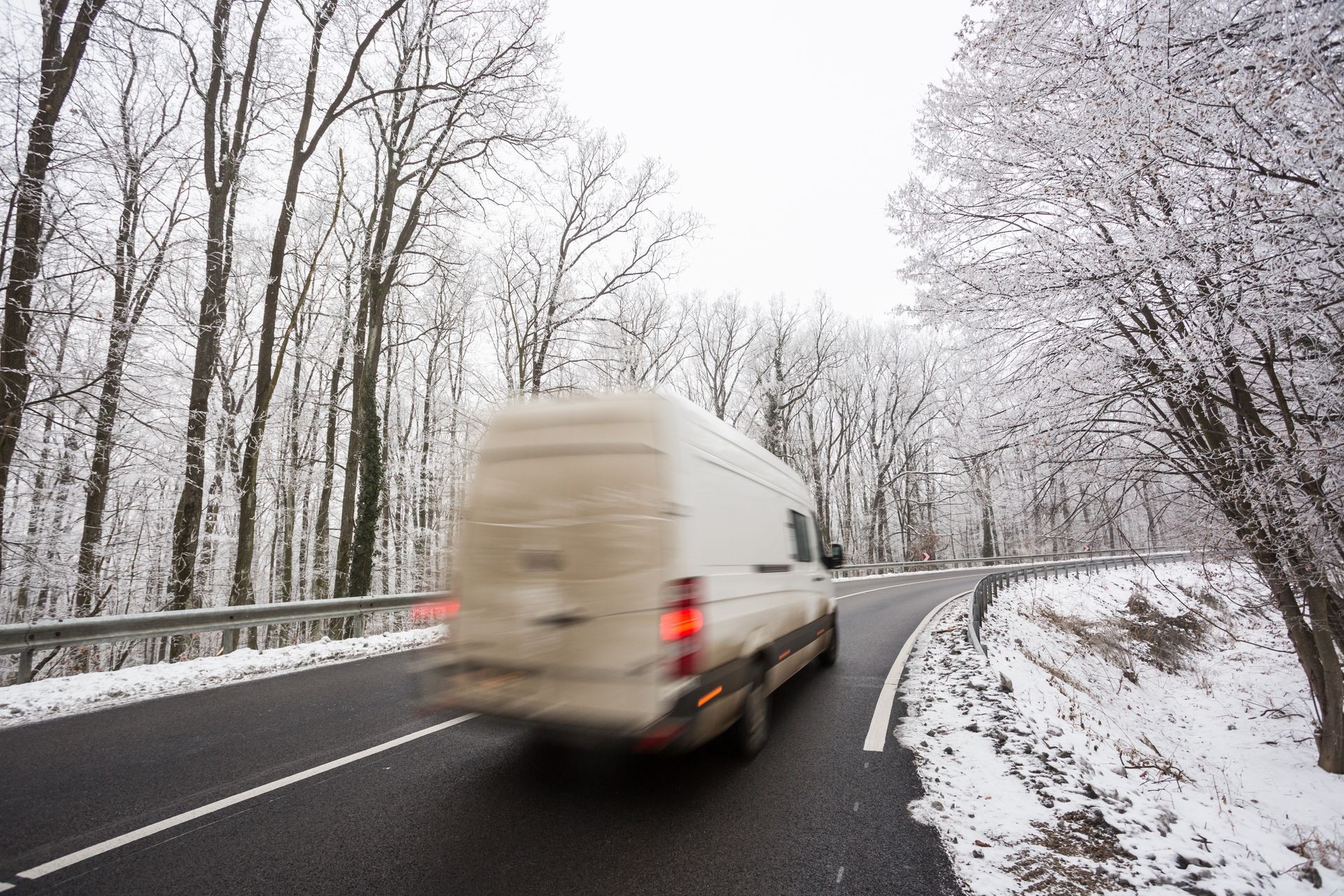 snowy road at cold wintertime with fast van